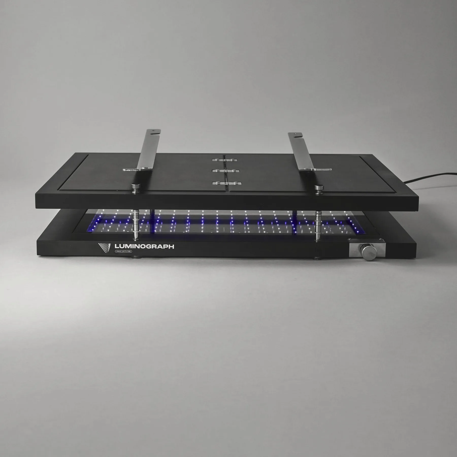 Luminograph A3+ from the front, press closed, arms folded, UV LEDs on
